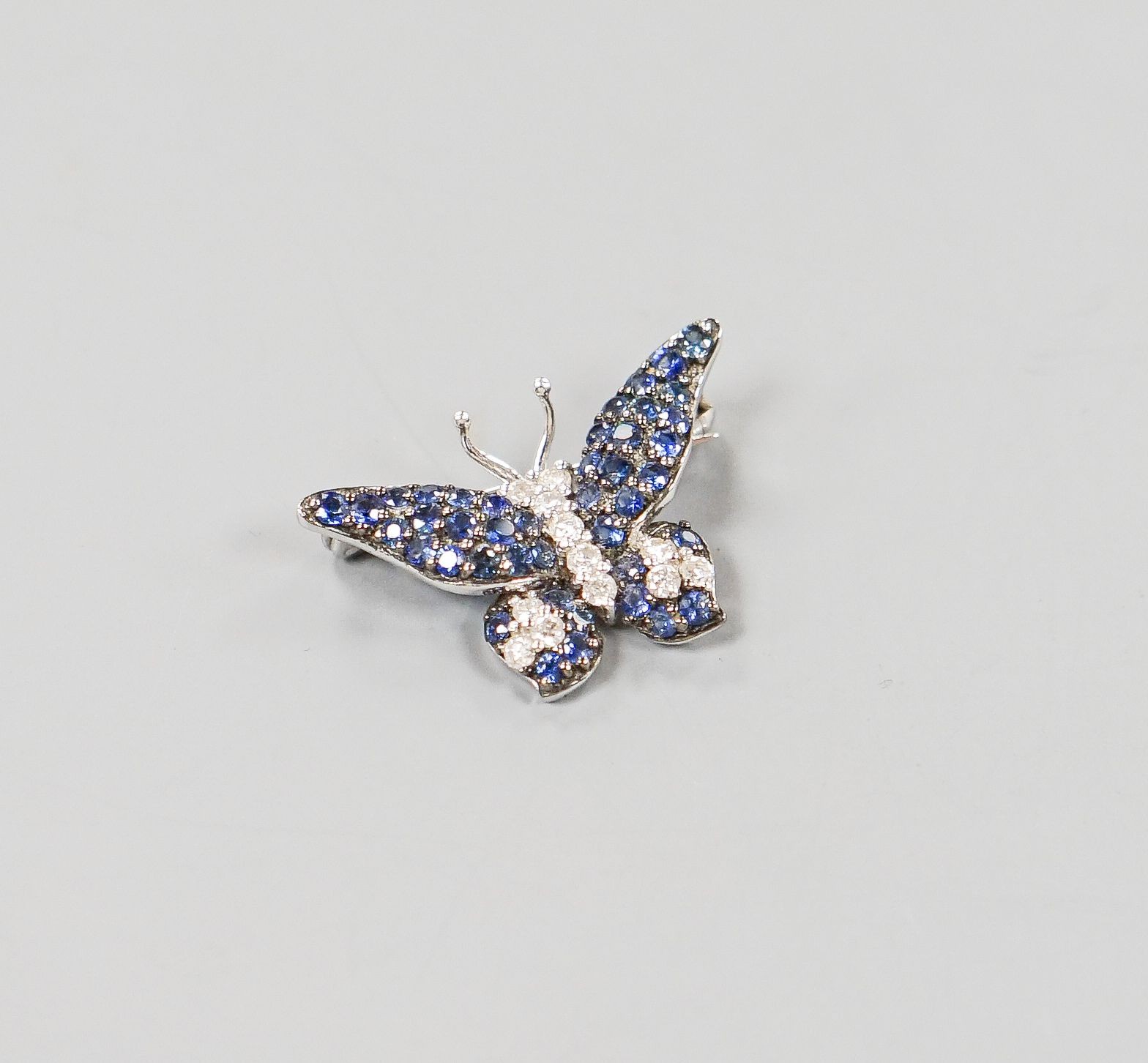 A modern 18ctwhite gold, pave set sapphire and diamond set butterfly brooch, 25mm, gross weight 4.5 grams.